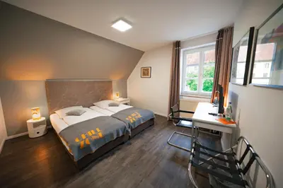 Ein Bett oder Betten in einem Zimmer der Unterkunft Hotel Bergbauer mit Late-Self-Check-IN