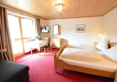 Ein Bett oder Betten in einem Zimmer der Unterkunft Gästehaus Sonnenbichl