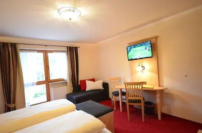 Ein Bett oder Betten in einem Zimmer der Unterkunft Gästehaus Sonnenbichl
