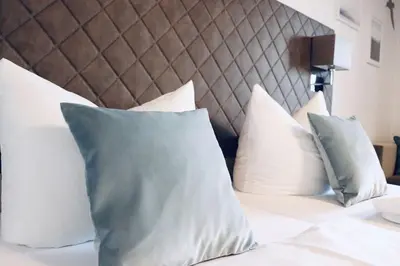 Ein Bett oder Betten in einem Zimmer der Unterkunft Hotel Garni Möwe am See