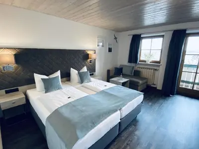 Ein Bett oder Betten in einem Zimmer der Unterkunft Hotel Garni Möwe am See
