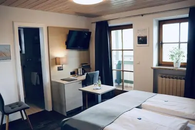 Ein Bett oder Betten in einem Zimmer der Unterkunft Hotel Garni Möwe am See