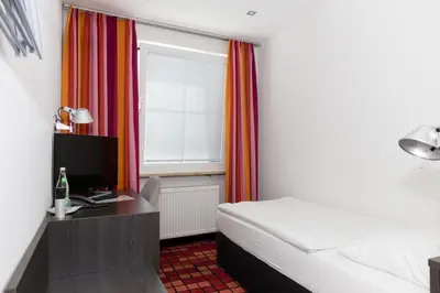 Ein Bett oder Betten in einem Zimmer der Unterkunft Altstadthotel Wetzel