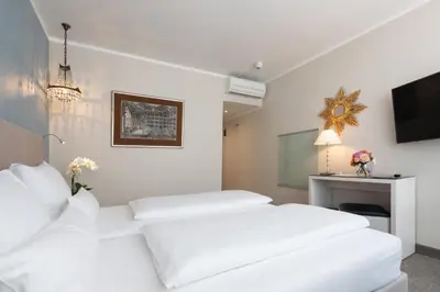 Ein Bett oder Betten in einem Zimmer der Unterkunft Hotel an der Oper
