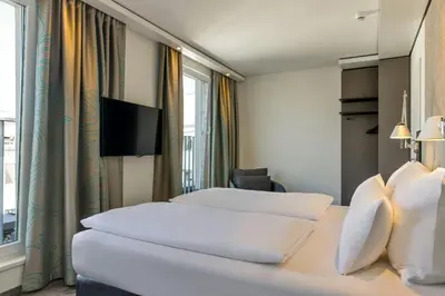 Ein Bett oder Betten in einem Zimmer der Unterkunft Motel One München Sendlinger Tor