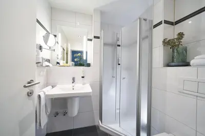 Ein Badezimmer in der Unterkunft Hotel am Hof