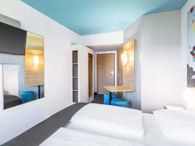 Ein Bett oder Betten in einem Zimmer der Unterkunft B&B Hotel München City-Ost