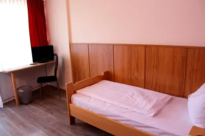 Ein Bett oder Betten in einem Zimmer der Unterkunft Hotel Atlas Sport