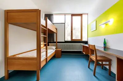 Ein Bett oder Betten in einem Zimmer der Unterkunft Jugendherberge Possenhofen