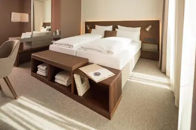 Ein Bett oder Betten in einem Zimmer der Unterkunft Das ACKER Hotel