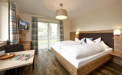 Ein Bett oder Betten in einem Zimmer der Unterkunft Gästehaus Alpina