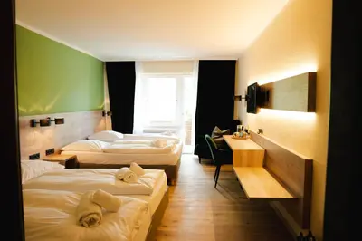 Ein Bett oder Betten in einem Zimmer der Unterkunft Ahorn Hotel