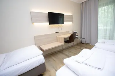 Ein Bett oder Betten in einem Zimmer der Unterkunft Ahorn Hotel