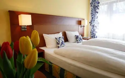 Ein Bett oder Betten in einem Zimmer der Unterkunft Ahorn Hotel