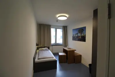 Ein Bett oder Betten in einem Zimmer der Unterkunft CVJM Jugendhotel München