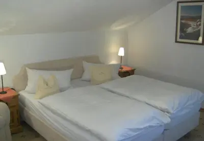 Ein Bett oder Betten in einem Zimmer der Unterkunft Gästehaus Baier am Bad