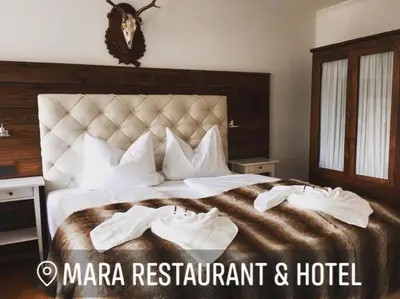 Ein Bett oder Betten in einem Zimmer der Unterkunft Mara Restaurant & Hotel