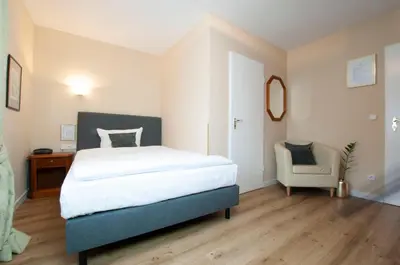 Ein Bett oder Betten in einem Zimmer der Unterkunft Hotel Altmünchen by Blattl