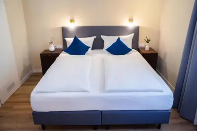Ein Bett oder Betten in einem Zimmer der Unterkunft Hotel Altmünchen by Blattl