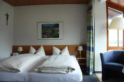 Ein Bett oder Betten in einem Zimmer der Unterkunft Hotel Garni Otto Huber