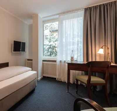 Ein Bett oder Betten in einem Zimmer der Unterkunft Hotel Olympic