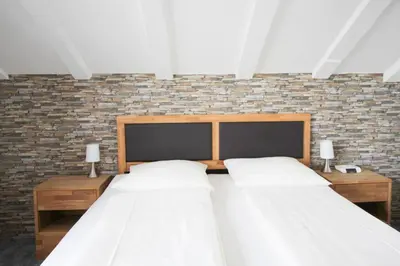 Ein Bett oder Betten in einem Zimmer der Unterkunft Hotel Brandl