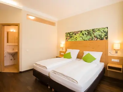 Ein Bett oder Betten in einem Zimmer der Unterkunft Hotel Brauereigasthof Amberger