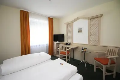 Ein Bett oder Betten in einem Zimmer der Unterkunft Hotel Leopold