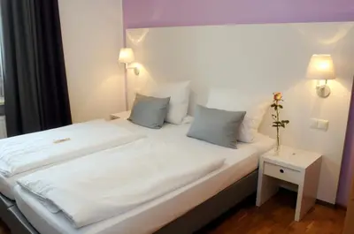 Ein Bett oder Betten in einem Zimmer der Unterkunft Hotel am alten Park