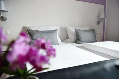 Ein Bett oder Betten in einem Zimmer der Unterkunft Hotel am alten Park