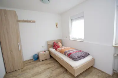 Ein Bett oder Betten in einem Zimmer der Unterkunft Pension Eichschmid / Röll´n Biergarten