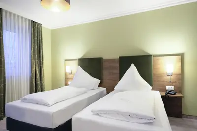 Ein Bett oder Betten in einem Zimmer der Unterkunft Hotel Römerstadt