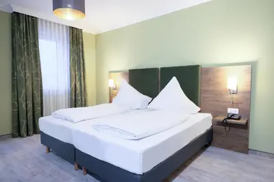 Ein Bett oder Betten in einem Zimmer der Unterkunft Hotel Römerstadt