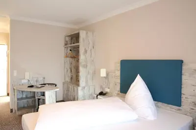 Ein Bett oder Betten in einem Zimmer der Unterkunft Hotel Römerstadt