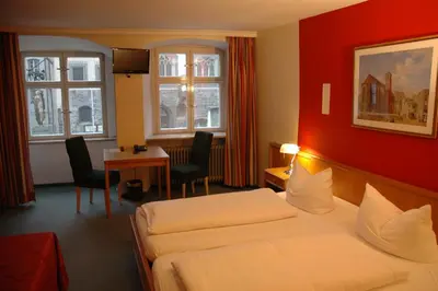 Ein Bett oder Betten in einem Zimmer der Unterkunft Hotel Paulanerstuben