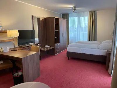 Ein Bett oder Betten in einem Zimmer der Unterkunft Hotel Gästehaus Forum am Westkreuz