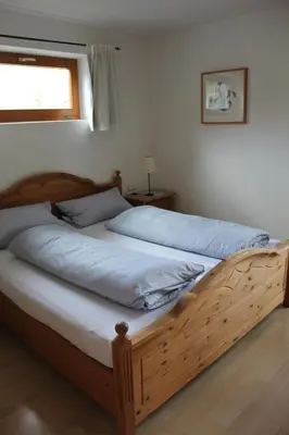Ein Bett oder Betten in einem Zimmer der Unterkunft Ferienwohnungen Almrausch