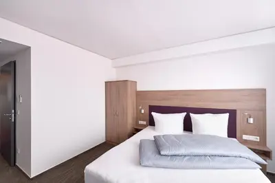 Ein Bett oder Betten in einem Zimmer der Unterkunft Hotel New In