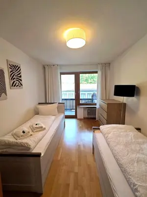 Ein Bett oder Betten in einem Zimmer der Unterkunft Hotel garni Königslinde - Wandern, Radeln, Skifahren & Genießen
