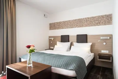 Ein Bett oder Betten in einem Zimmer der Unterkunft Hotel Drei Rosen
