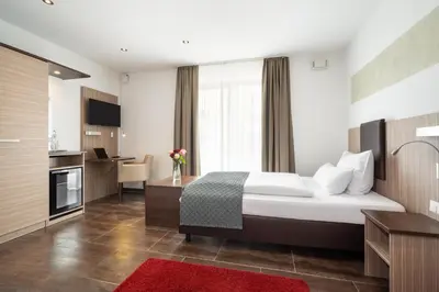 Ein Bett oder Betten in einem Zimmer der Unterkunft Hotel Drei Rosen