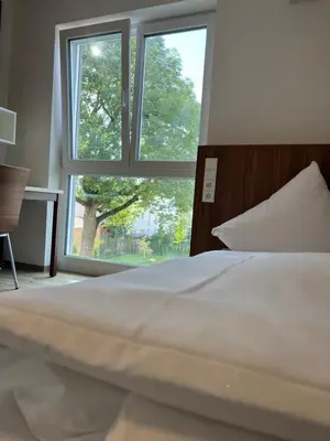 Ein Bett oder Betten in einem Zimmer der Unterkunft Business Boardinghouse Augsburg, zentral, ruhig & mit Parkplatz