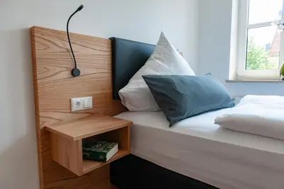 Ein Bett oder Betten in einem Zimmer der Unterkunft Hotel Drei Tannen