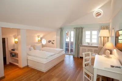 Ein Bett oder Betten in einem Zimmer der Unterkunft Landhaus Marinella Hotel Garni