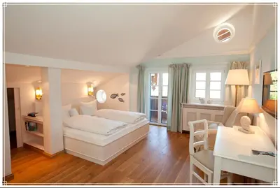 Ein Bett oder Betten in einem Zimmer der Unterkunft Landhaus Marinella Hotel Garni