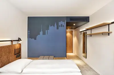 Ein Bett oder Betten in einem Zimmer der Unterkunft H2 Hotel München Olympiapark