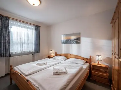 Ein Bett oder Betten in einem Zimmer der Unterkunft Ferienwohnanlage Brünnstein Kaiserhimmel mit Schwimmbad und Sauna