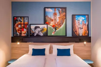 Ein Bett oder Betten in einem Zimmer der Unterkunft Ramada Encore by Wyndham Munich Messe