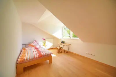 Ein Bett oder Betten in einem Zimmer der Unterkunft Gästehaus Hubertus