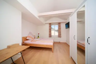 Ein Bett oder Betten in einem Zimmer der Unterkunft Gästehaus Hubertus